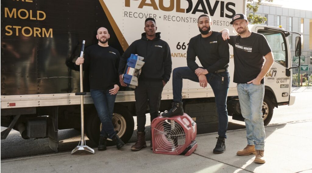 Paul Davis Restoration team standing in front of service truck with equipment in Reno and Tahoe NV, providing water damage, mold, and storm restoration services